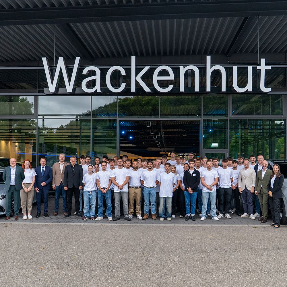 Viele Personen vor Gebäude mit Schriftzug Wackenhut